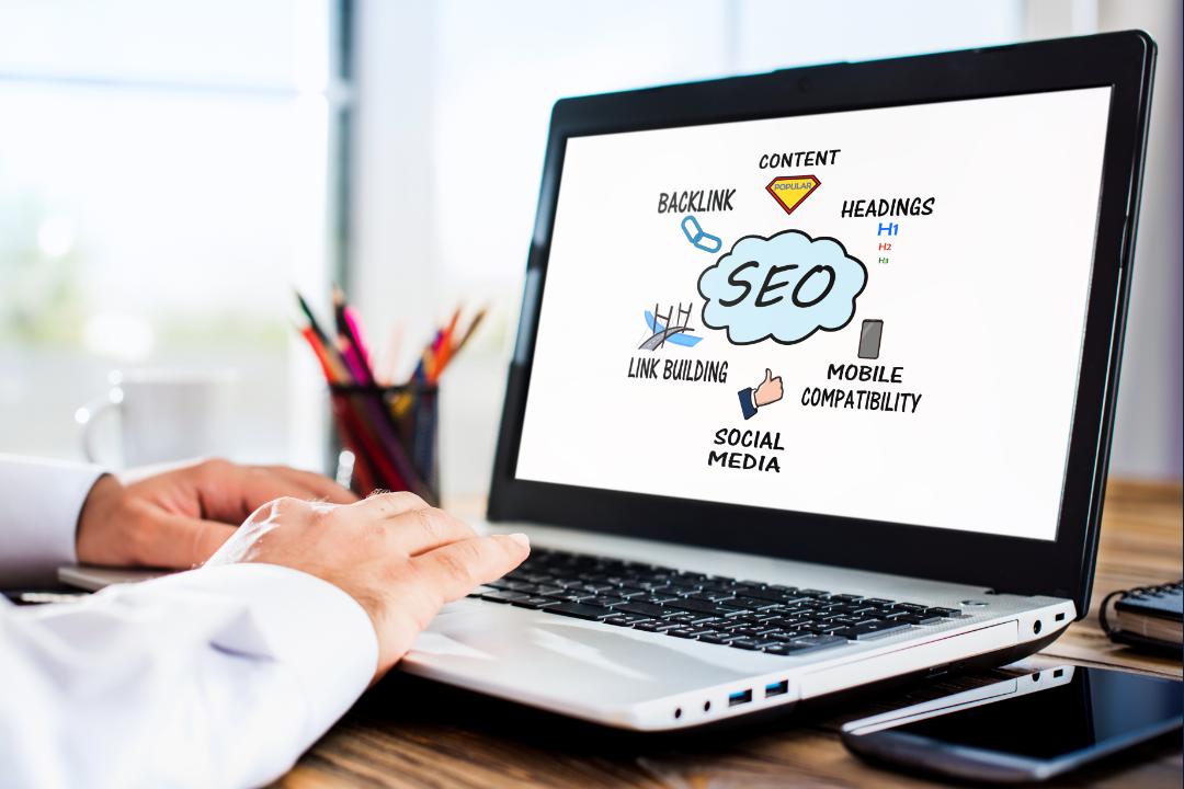 A creative illustration showing the concept of SEO copywriting: a laptop on a desk with a document open, surrounded by symbols of writing (pens, paper), SEO elements (graphs, charts, magnifying glass), and engagement icons (hearts, chat bubbles, clicks), in a bright, modern digital workspace.